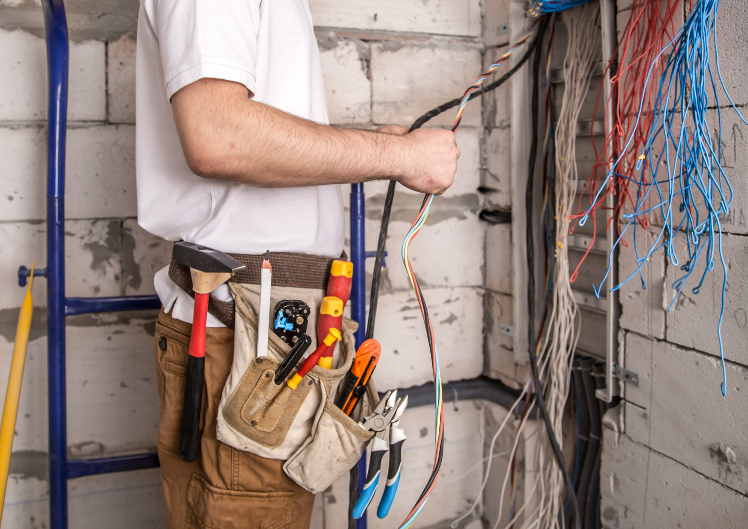 electrician-working-near-board-with-wires-installation-connection-electrics